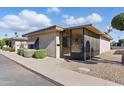 Inviting single-story home with tidy landscaping, featuring a welcoming screened-in front porch at 13621 N 98Th Ave # E, Sun City, AZ 85351