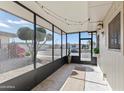 Bright screened porch with tile floor, offering a view of the landscaped yard at 13621 N 98Th Ave # E, Sun City, AZ 85351
