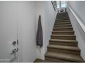 Carpeted stairway leading to the upper level of the modern townhouse at 14870 W Encanto Blvd # 2123, Goodyear, AZ 85395