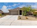 Charming single-story home with a two car garage, desert landscaping, and a welcoming front entrance at 17532 W Copper Ridge Dr, Goodyear, AZ 85338