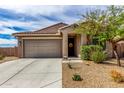 Charming single-story home with a two car garage, desert landscaping, and a welcoming front entrance at 17532 W Copper Ridge Dr, Goodyear, AZ 85338
