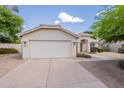 Well-maintained single-Gathering home featuring a spacious driveway and two-car garage at 1821 N 74Th Pl, Mesa, AZ 85207