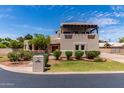 Stunning home exterior with a front yard featuring mature landscaping, stucco facade, and covered second story patio at 1954 N Calle Maderas --, Mesa, AZ 85213