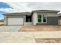 Newly constructed home with a neutral color palette, attached two-car garage, and tidy landscaping at 22709 E Saddle Way, Queen Creek, AZ 85142