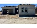 Contemporary home under construction showcasing a two-car garage and bright window accents at 22709 E Saddle Way, Queen Creek, AZ 85142