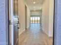 Inviting entry hallway featuring tile floors leading to an open living space at 22709 E Saddle Way, Queen Creek, AZ 85142
