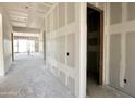 Hallway of a new construction home with drywall and framing for the ceiling at 22709 E Saddle Way, Queen Creek, AZ 85142