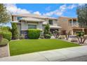 Attractive home with neat landscaping, artificial turf, and charming curb appeal on a sunny day at 2496 E Lindrick Dr, Gilbert, AZ 85298