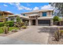 Beautiful house with a well-maintained lawn, paver driveway, and three-car garage showcasing its exterior at 2496 E Lindrick Dr, Gilbert, AZ 85298