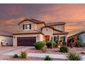 Stunning two-story home featuring desert landscaping, complemented by a brown garage door and shuttered windows at 2607 W Gray Wolf Trl, Phoenix, AZ 85085