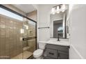 Bathroom boasting a glass-enclosed shower, modern vanity with a marble countertop, and chic fixtures at 26914 W Renee Dr, Buckeye, AZ 85396