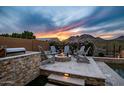 Outdoor fire pit with stone surround and seating, perfect for entertaining and relaxation at 27276 N 81St Ln, Peoria, AZ 85383