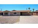 Charming single-story home with a covered carport and low-maintenance desert front yard at 3513 W Maryland Ave, Phoenix, AZ 85019