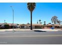 Street view of a single-story home with desert landscaping and mature palm trees at 3513 W Maryland Ave, Phoenix, AZ 85019
