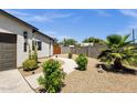 The home features a walkway to the front door, desert landscaping with a palm tree and a rock lawn at 3806 N 23Rd Ave, Phoenix, AZ 85015