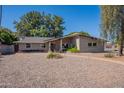 Single-story brick home with a well-manicured, low-maintenance gravel yard at 405 E Stanford Ave, Gilbert, AZ 85234