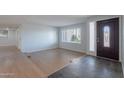 Bright and airy living room with wood floors and a modern front door at 405 E Stanford Ave, Gilbert, AZ 85234