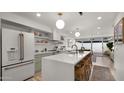 Sunlit kitchen with island seating, open shelving, and stainless steel appliances for the ultimate cooking experience at 4411 N 40Th St # 40, Phoenix, AZ 85018