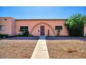 Charming home with unique arched entrance and low-maintenance desert landscaping at 4625 W Thomas Rd # 71, Phoenix, AZ 85031