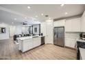 Bright, open kitchen with stainless steel appliances and an island overlooking the living area at 4698 E French Rd, San Tan Valley, AZ 85143