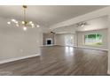 Open floor plan boasts wood-look tile, modern lighting, and access to the outdoor space at 4913 E Acoma Dr, Scottsdale, AZ 85254