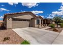 Attractive home showcasing a well-maintained yard, two-car garage, and classic desert architecture at 5621 S 30Th Gln, Phoenix, AZ 85041