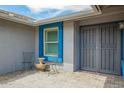 Cozy front porch with decorative window trim, a wrought iron security door, and quaint sitting area at 620 W Crofton St, Chandler, AZ 85225