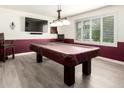 Spacious game room with a large window, a wainscot wall, and a pool table under a three-lamp fixture at 620 W Crofton St, Chandler, AZ 85225