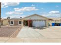 Charming single-story home showcasing a two-car garage, brick accents and low-maintenance desert landscaping at 638 W Pantera Ave, Mesa, AZ 85210