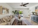 Bright living room with hardwood floors, modern ceiling fan, and sliding glass doors leading to outdoor patio at 638 W Pantera Ave, Mesa, AZ 85210