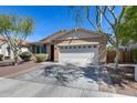 Attractive single-story home with a two-car garage and low-maintenance desert landscaping at 7634 W Redbird Rd, Peoria, AZ 85383