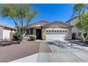 Inviting single-story home with a two-car garage and desert landscaping at 7634 W Redbird Rd, Peoria, AZ 85383