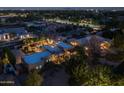 An aerial view of a house at night shows the pool and surrounding neighborhood at 8675 S College Ln, Tempe, AZ 85284