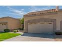 Single-story home featuring a two-car garage, driveway, and desert landscaping under a blue, partly cloudy sky at 8839 W Rimrock Dr, Peoria, AZ 85382