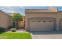 Charming home featuring a two-car garage, desert landscaping, and a well-manicured lawn under a partly cloudy sky at 8839 W Rimrock Dr, Peoria, AZ 85382
