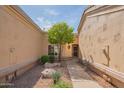 Inviting front yard with desert landscaping, decorative rocks, a tree, and a walkway leading to the front door at 8839 W Rimrock Dr, Peoria, AZ 85382