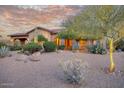 Charming home featuring desert landscaping with mature trees, cacti, and a warm, inviting color palette at 9715 E Allison Way, Scottsdale, AZ 85262