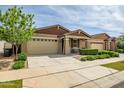 Beautiful single-story home featuring a two-car garage and manicured landscaping at 9829 E Talon Ave, Mesa, AZ 85212