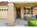 Welcoming front porch with seating and decorative 'SPRING' sign at 9829 E Talon Ave, Mesa, AZ 85212