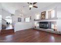 Spacious living room featuring a fireplace, high ceilings, and wood-look flooring at 10909 W Frier Dr, Glendale, AZ 85307