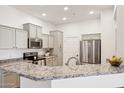 Stylish kitchen featuring granite counters, stainless steel appliances, and bright lighting at 14575 W Mountain View Blvd # 11308, Surprise, AZ 85374