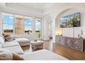 A living room features balcony access, a modern TV, and decorative furnishings at 14575 W Mountain View Blvd # 11308, Surprise, AZ 85374