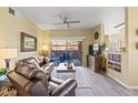Comfortable living room features a ceiling fan and access to an outdoor patio at 14950 W Mountain View Blvd # 7111, Surprise, AZ 85374