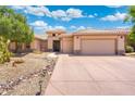 Inviting single-story home featuring a three-car garage and meticulously landscaped front yard at 15133 W Wildfire Dr, Surprise, AZ 85374