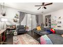 Comfortable living room with a sectional sofa, area rug, and plenty of natural light at 15423 N 22Nd Dr, Phoenix, AZ 85023