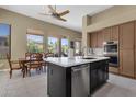 Modern kitchen with stainless steel appliances, an island, and a breakfast nook overlooking the pool at 15608 E Chaparral Way, Fountain Hills, AZ 85268