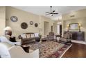 Comfortable living room with a ceiling fan, neutral walls, and stylish decor and furnishings at 15608 E Chaparral Way, Fountain Hills, AZ 85268