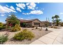 Beautiful, low-maintenance desert landscaping adorns this single-Gathering home with tile roof at 15691 W Arbor Trl, Surprise, AZ 85374