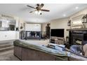 Open concept living room with a cozy fireplace, neutral colors, and a partial view of the kitchen at 15834 E Sunflower Dr # 2, Fountain Hills, AZ 85268