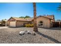 Front exterior view of home with desert landscaping and palm trees in the yard on a sunny day at 16814 N 31St Ave, Phoenix, AZ 85053